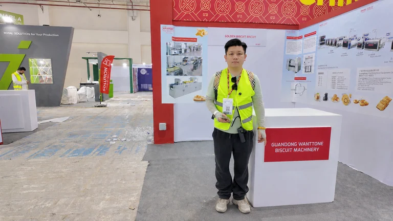 A person wearing a high-visibility vest in front of the Wanttone booth in Egypt