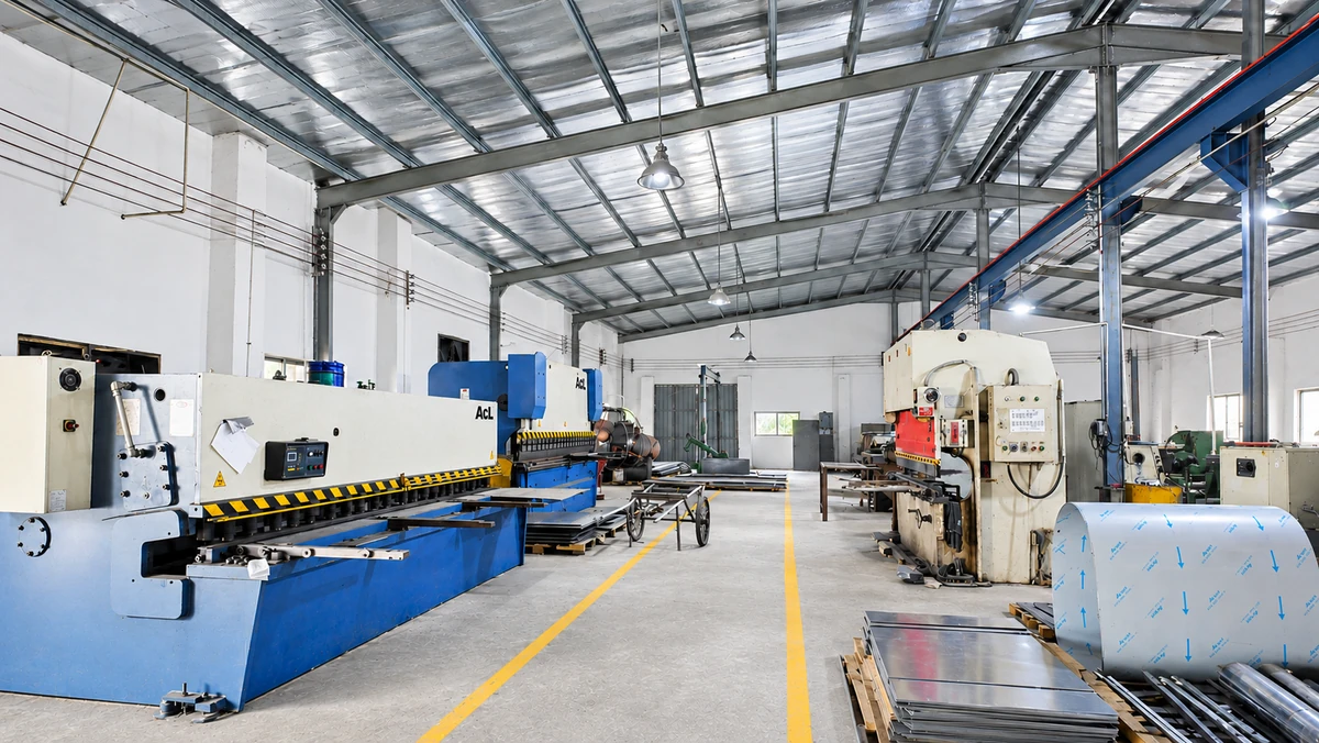 Metalworking machinery and sheet-metal stock inside the Wanttone workshop
