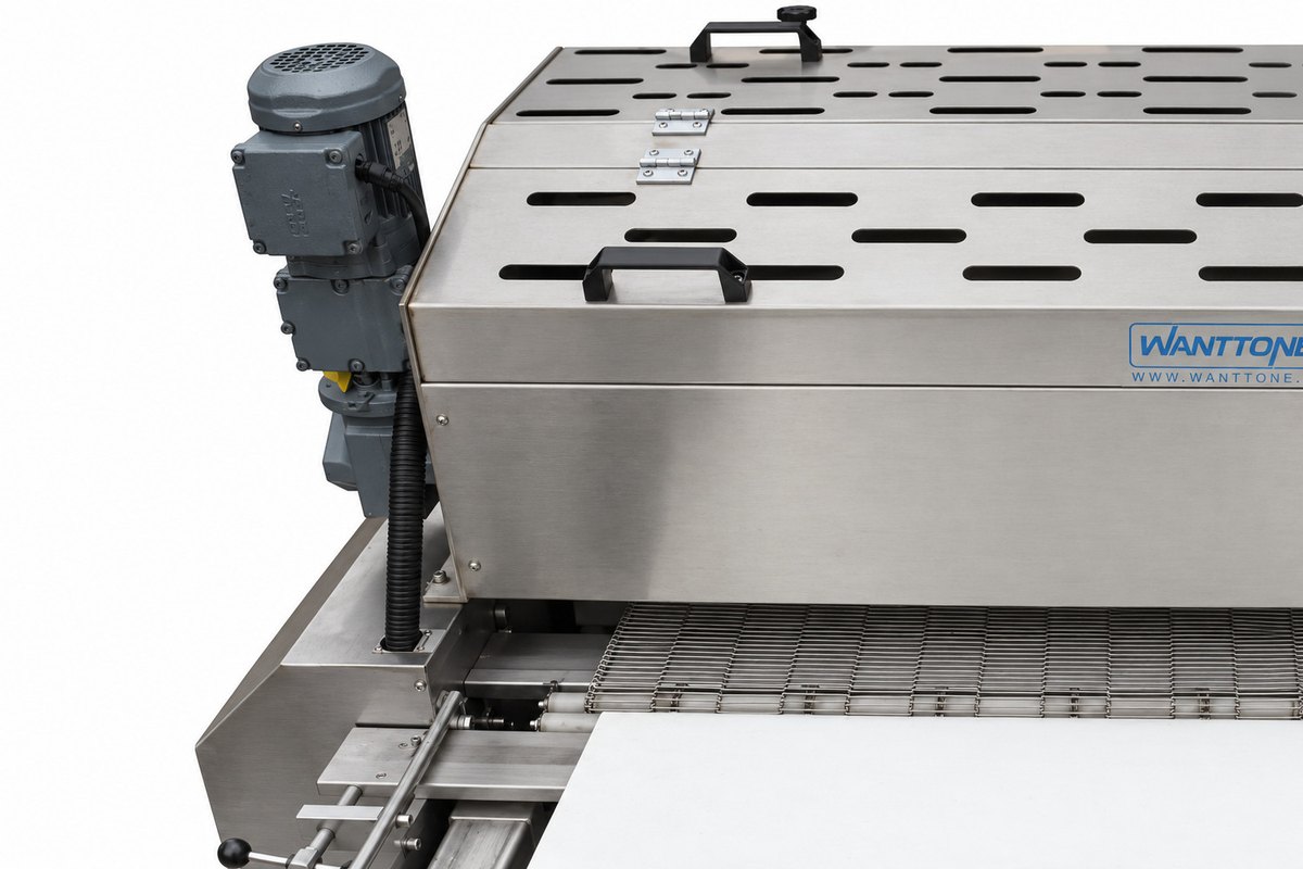 Original detail of a sprinkle machine showing the left drive assembly, slotted cover and mesh conveyor